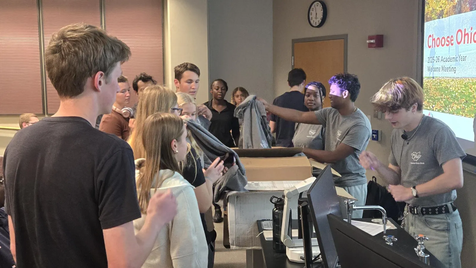 Scholars Picking up t-shirts