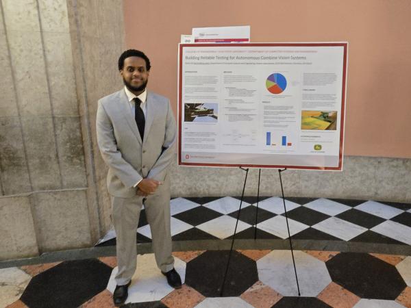 Bashir in front of his poster presentation