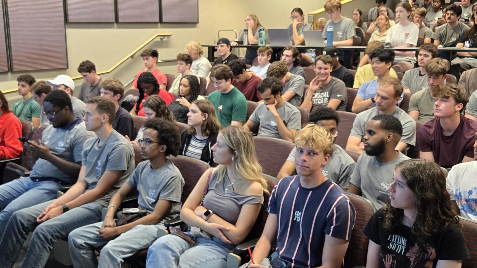 COF scholars listening to a presentation